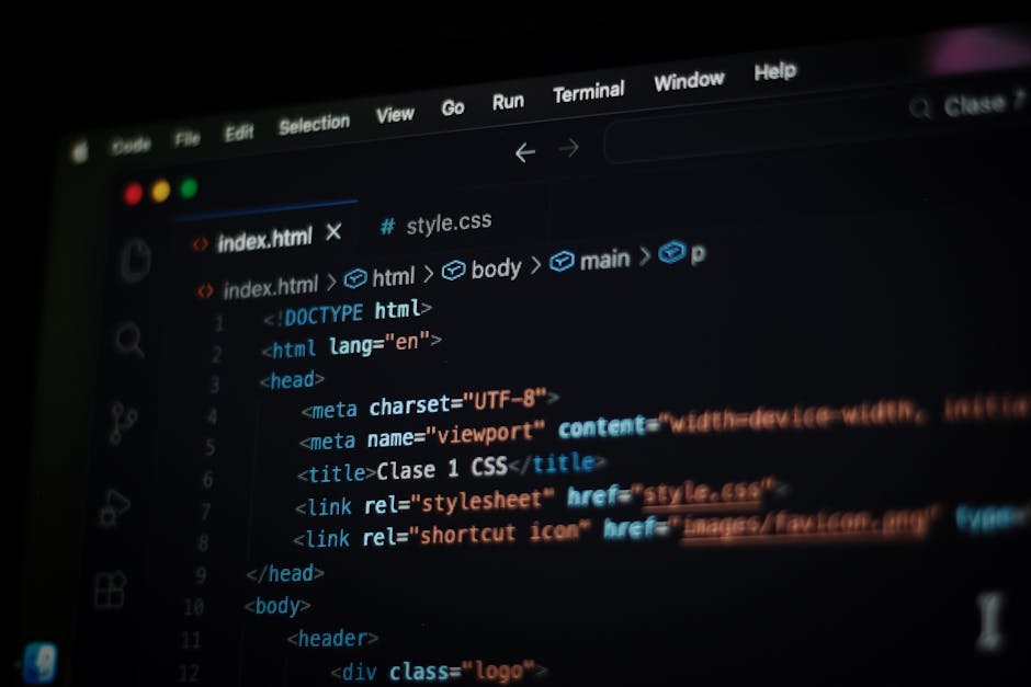 A close-up image of a computer screen displaying a code editor with HTML and CSS code, featuring tags such as <html>, <head>, <body>, and stylesheet links. The code is highlighted wi
